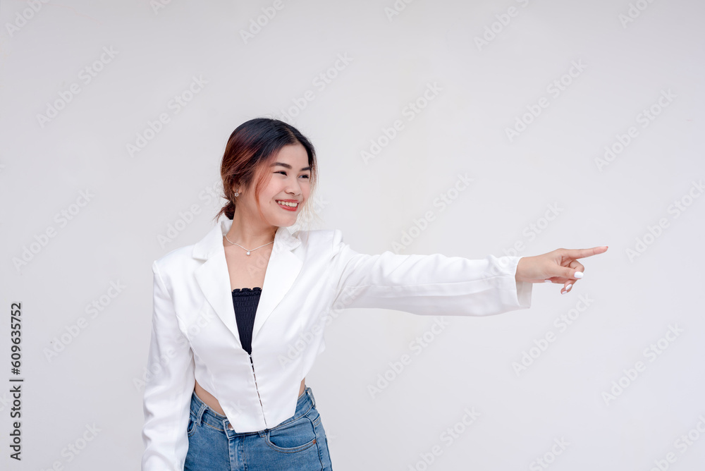 A helpful and friendly young woman faced sideways and pointing to the right. Isolated on a white background. A helpful and friendly young woman faced sideways and pointing to the right. Isolated on a white background.