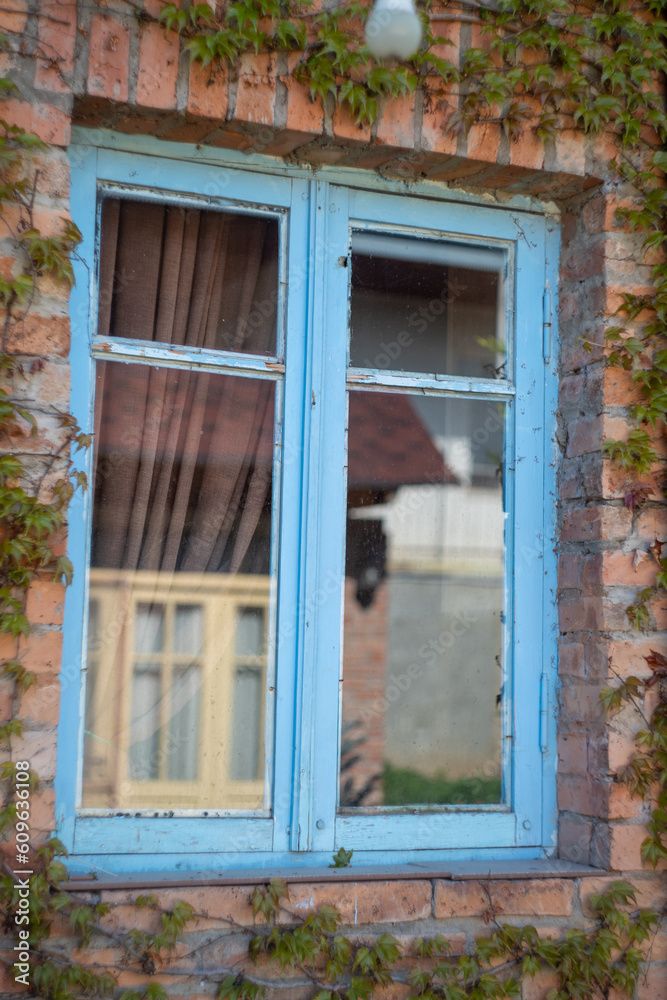 Old blue window and red brick wall