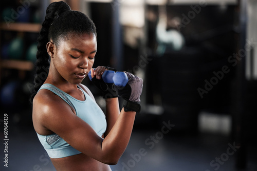 Fitness  dumbbell or strong black woman training  exercise or workout for powerful arms or muscles. Wellness  healthy or African girl lifting dumbbells  weights or exercising biceps in gym studio