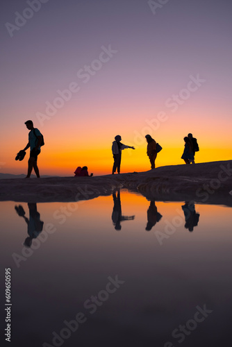 People walking by the lake at sunset, silhouette, Pamukkale - Turkey
