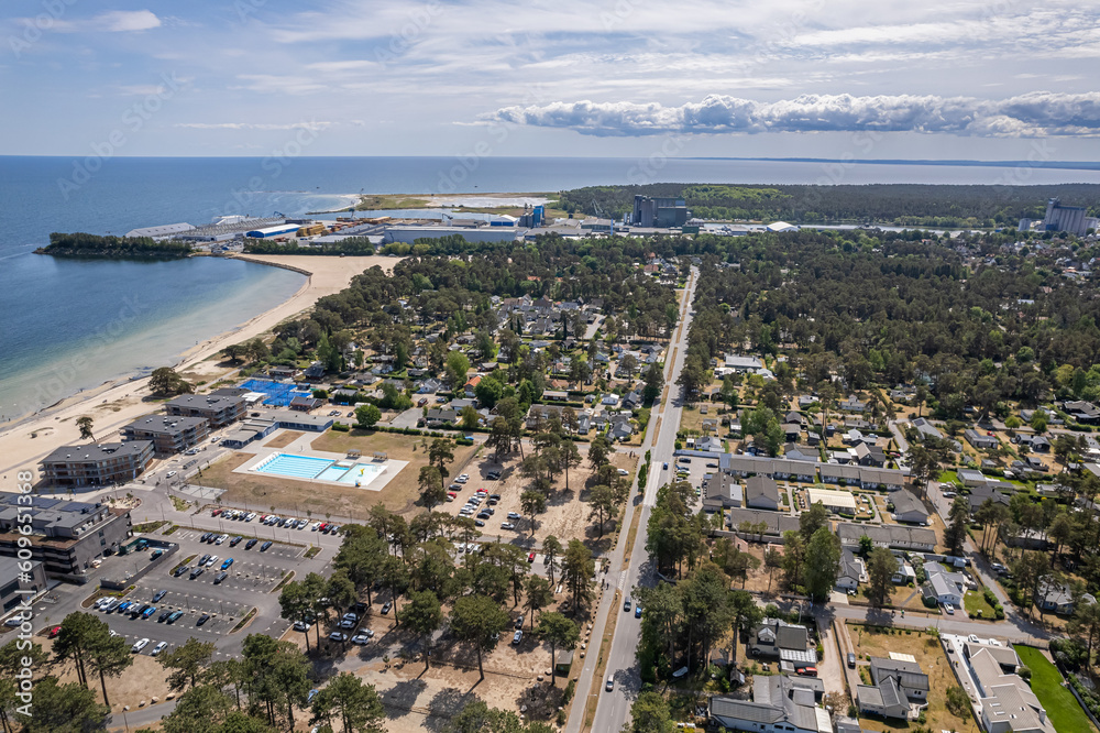 Aerial view private houses close to the beach and sea. Beautiful sea, maritime landscape, seascape. Forest near the beach. Resort and recreational area, luxury real estate.  