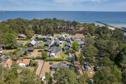 Aerial view private houses close to the beach and sea. Beautiful sea, maritime landscape, seascape. Forest near the beach. Resort and recreational area, luxury real estate. 