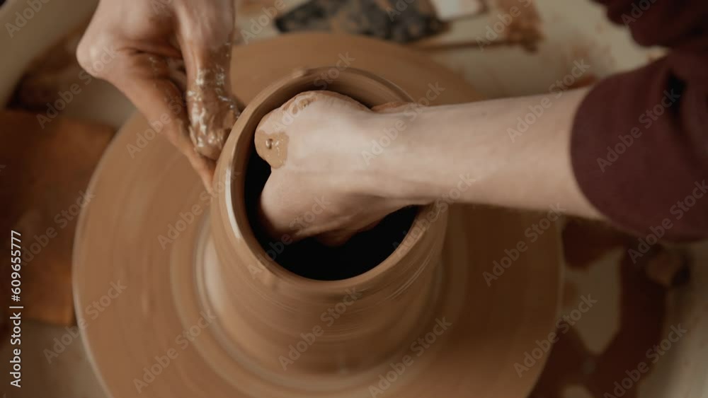 Talented male potter creates vase from clay. Overhead view of man