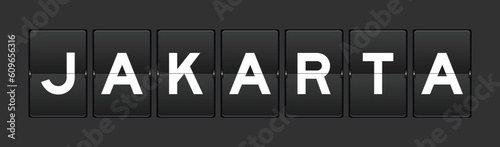 Black color analog flip board with word jakarta on gray background