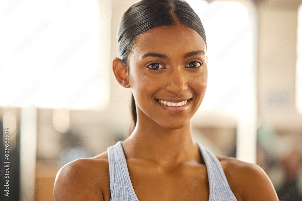 Fitness, portrait or happy Indian woman at gym for a workout, exercise or training for wellness. Face of sports girl or proud female athlete smiling or relaxing with positive mindset in health club