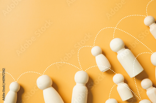 Social gathering and business networking global communication linking line on the wooden figurines group as teamwork community meeting club yellow background. People lifestyles social media concept.