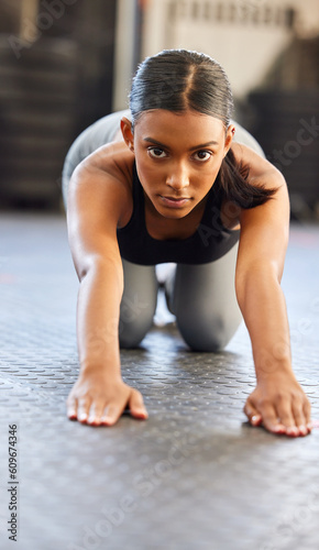 Portrait, fitness or woman stretching spine in gym preparation for exercise, workout or wellness. Face of girl, warm up or flexible Indian athlete exercising for mobility training or back flexibility