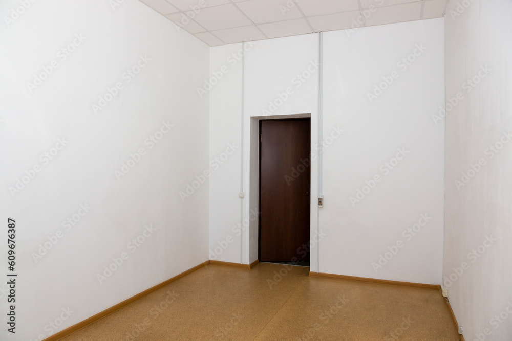 Interior of an empty room with a closed door Interior of an empty room with a closed door