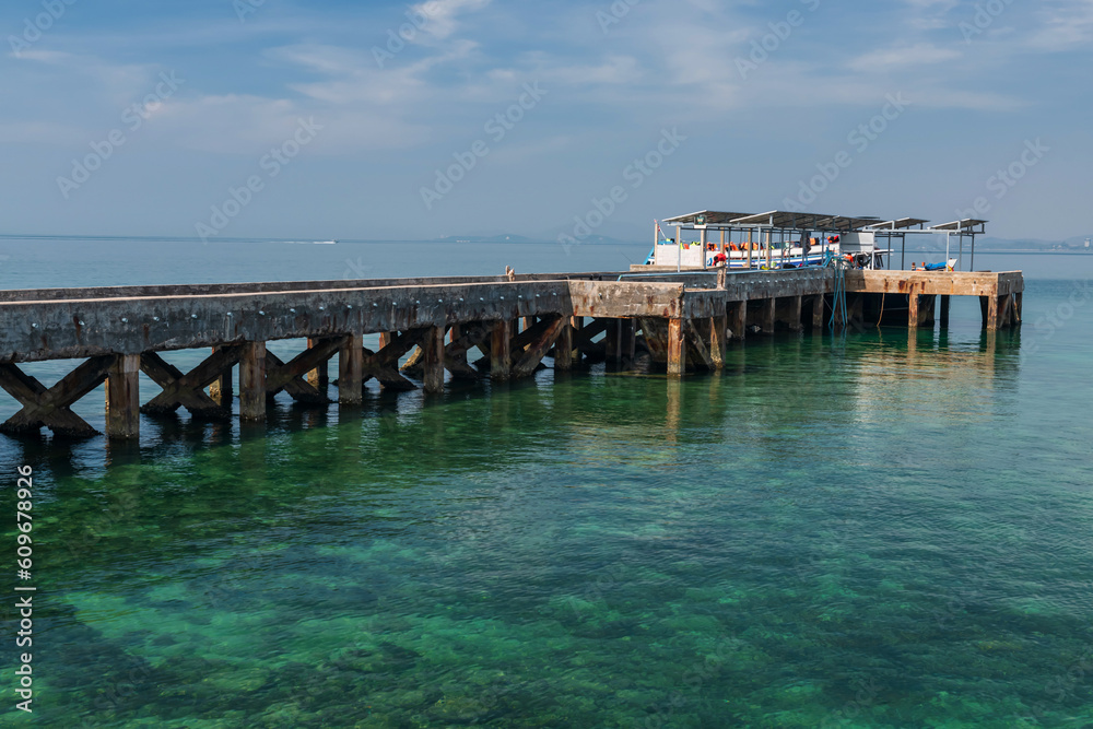 Ko Man Nai port with tourist ship on turquoise sea, Rayong