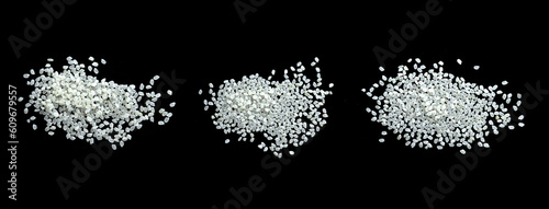 Heaps of uncooked Japanese short grain rice piled together isolated on black background.