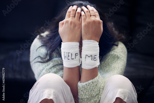 Wrist, depression and woman with help on bandage for suicide, self harm or person in dark mental health crisis. Bandages, girl and injury from depressed accident, problem or mistake in cutting wrists