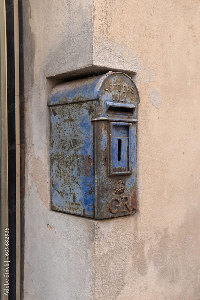 Vintage, blauer Briefkasten der Post verziert mit der Aufschrift 