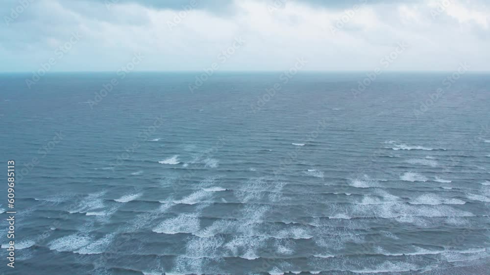4K aerial shot of Dark clouds over ocean during monsoon season. Ocean waves at Mandvi beach, Kutch, India. Nature landscape. Travel background. 4K aerial shot of Dark clouds over ocean during monsoon season. Ocean waves at Mandvi beach, Kutch, India. Nature landscape. Travel background.