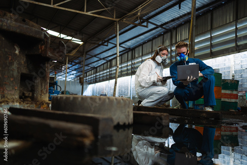 Chemical specialist working and inspecting chemical tanks in a factory. Inspection of chemical tanks in industrial plants.