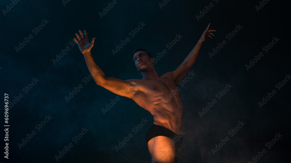 A muscular athlete in an epic pose arms outstretched, fog and smoke on the background, warm mystical light from below, the concept of the antique beauty of the human body