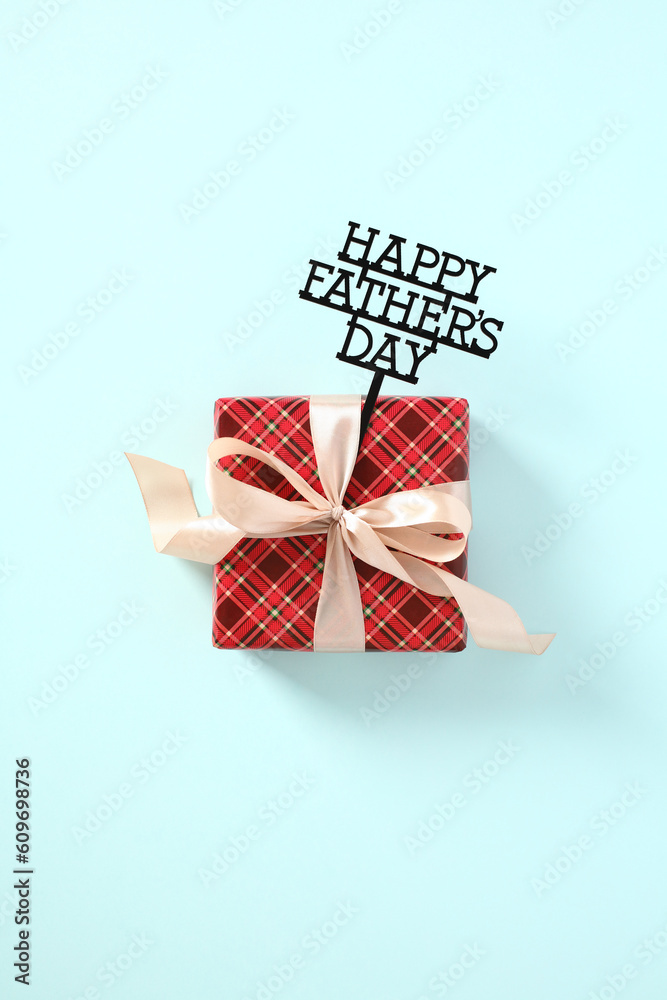 Gift box with message Happy Fathers Day on blue background. Happy Fathers Day concept