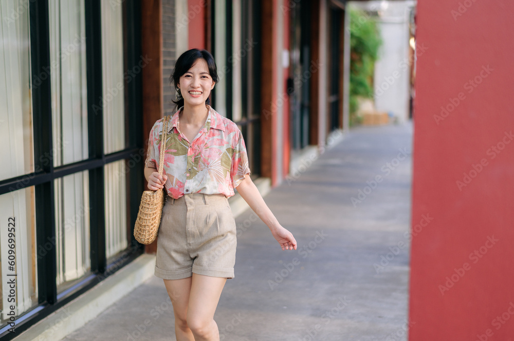 Portrait beautiful young asian woman on summer holiday vacation trip in Thailand. Young hipster female tourist sightseeing summer urban Bangkok destination. Asia summer tourism concept.