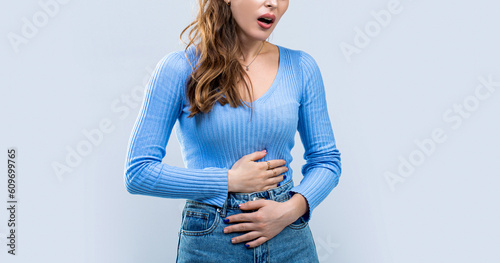 Woman touching his stomach. Stomach pain and others stomach disease concept. Girl having a stomachache. Young woman suffering from abdominal pain. Woman Stomach Ache photo