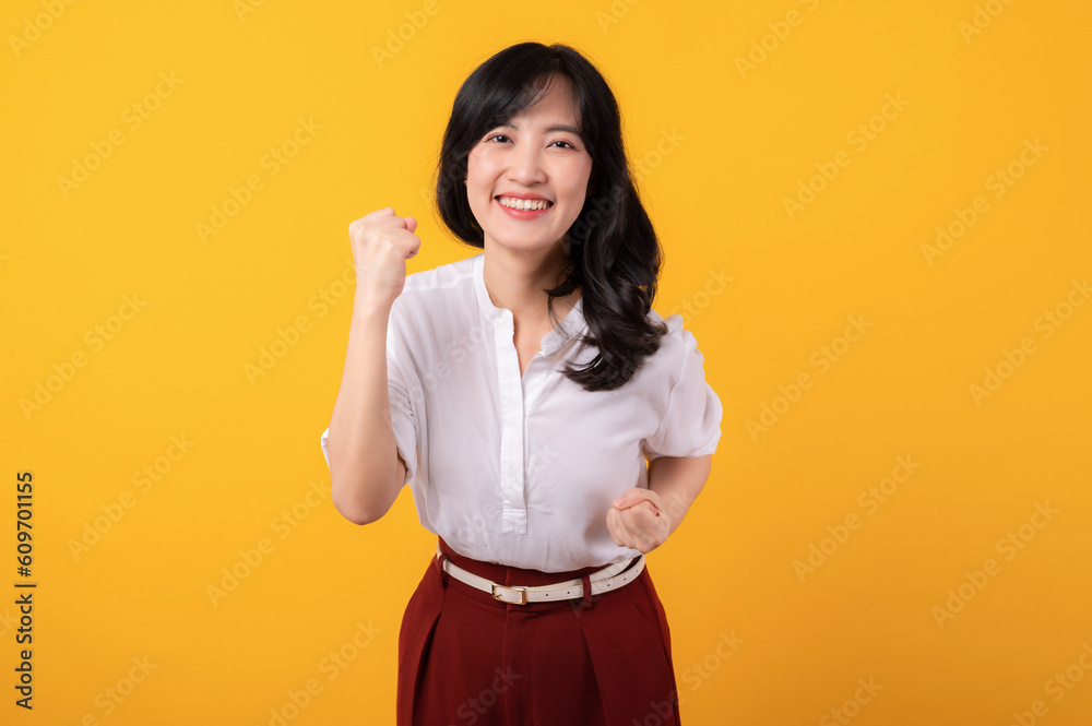 Portrait beautiful young asian woman enterpriser happy smile wearing white shirt and red plants celebrating her success isolated on yellow background. Portrait beautiful young asian woman enterpriser happy smile wearing white shirt and red plants celebrating her success isolated on yellow background.