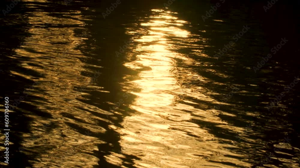 Abstract nature background 4K slow motion video clip of golden light reflecting on sea, lake or river water with liquid gold ripples and reflections
Abstract nature background 4K slow motion video clip of golden light reflecting on sea, lake or river water with liquid gold ripples and reflections