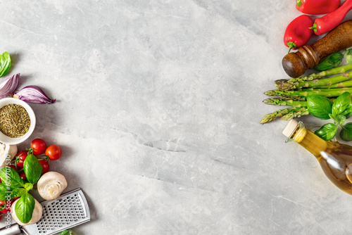 Obraz na płótnie Food cooking ingredients background with fresh vegetables, herbs, spices and olive oil on white stone table top view. Healthy vegetarian eating w salonie