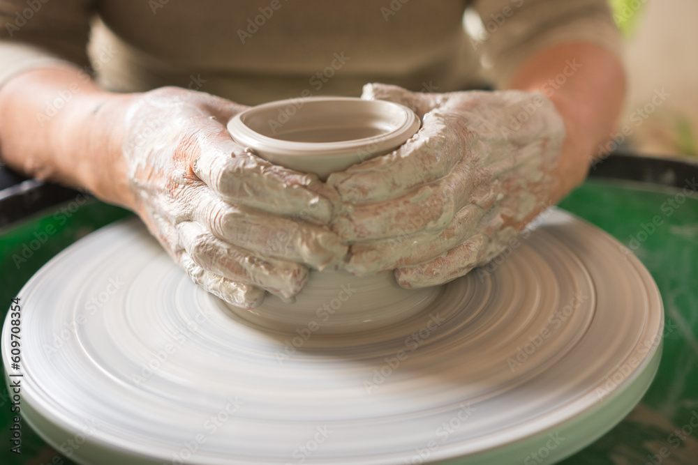 Woman hands making a pottery with clay