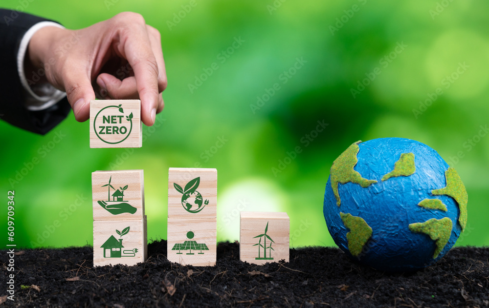 Businessman hand with paper globe and net zero symbol cube for eco ...