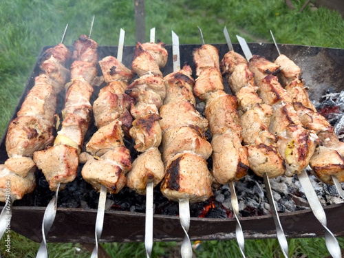 Kebabs strung on skewers are fried on the grill