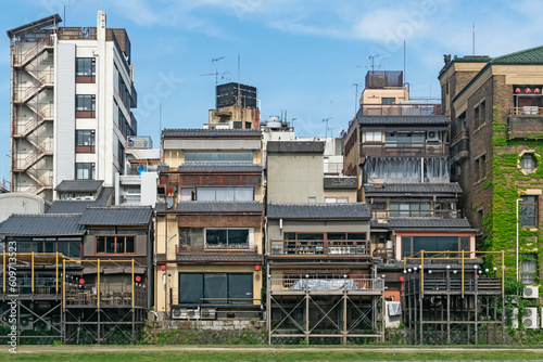 Japanese abstract urban background featuring details of chaotic vintage city buildings and urban skyline in summer day in Kyoto, Japan.   