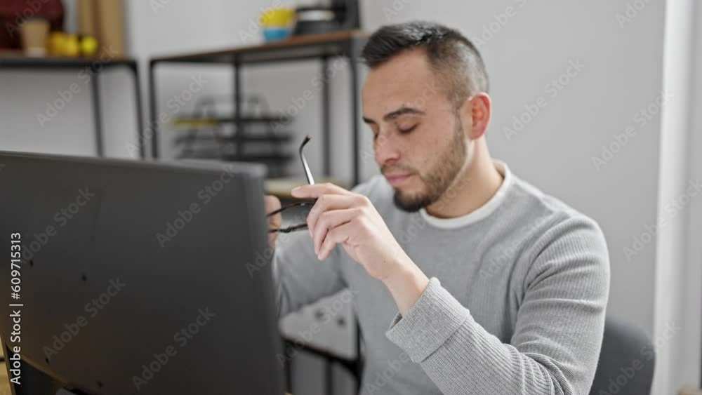 Hispanic man business worker stressed using computer at office Hispanic man business worker stressed using computer at office