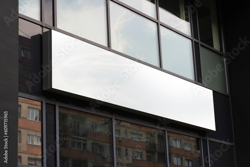 Blank white restaurant or shop sign mockup, large billboard banner on a storefront template.