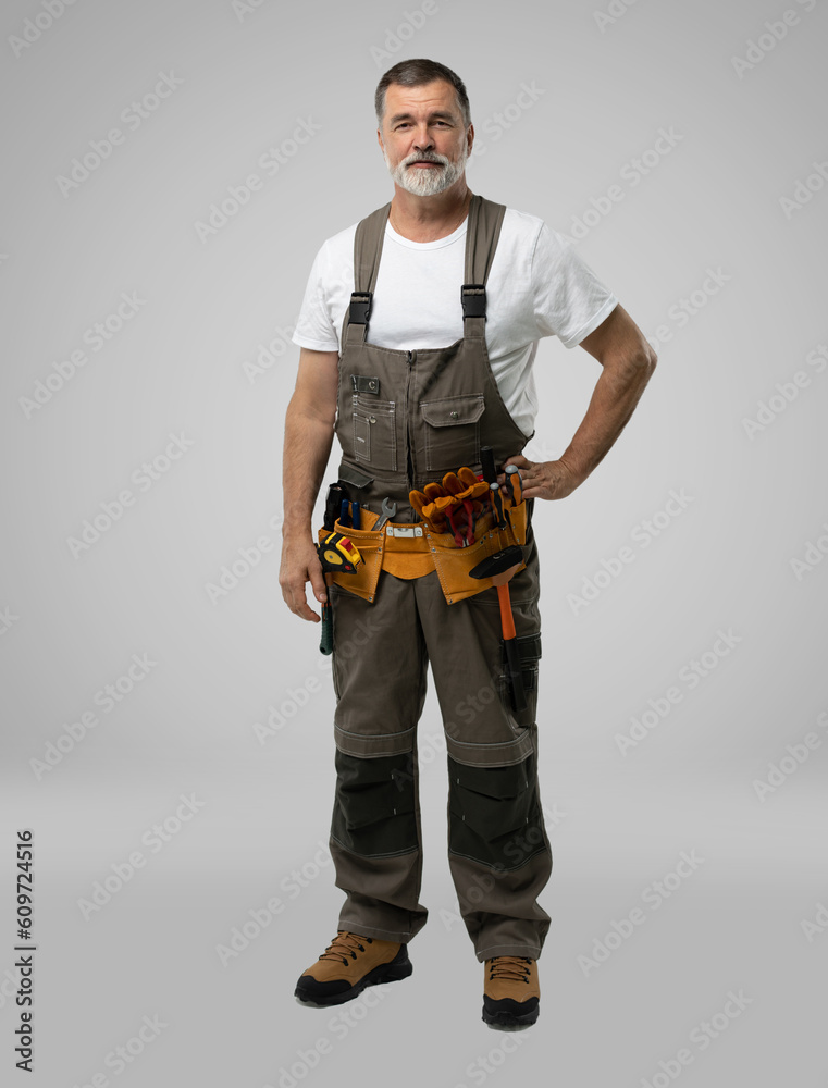 full lenght of mature happy handyman isolated on white background. full lenght of mature happy handyman isolated on white background.