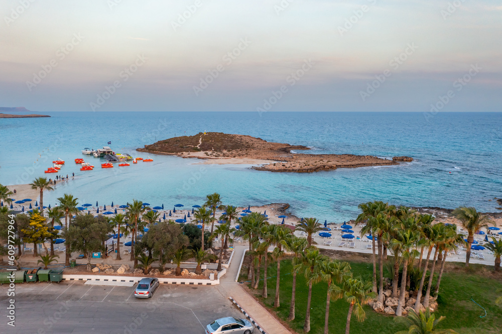 Obraz premium Cyprus -Nissi Beach in Ayia Napa, clean aerial photo of famous tourist beach in Cyprus, the place is a known destination on island and is formed from a smaller island just near the main shore