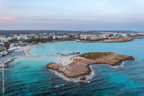 Cyprus -Nissi Beach in Ayia Napa, clean aerial photo of famous tourist beach in Cyprus, the place is a known destination on island and is formed from a smaller island just near the main shore photo