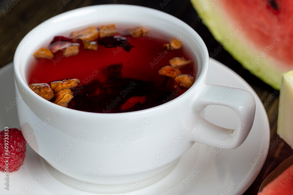 Red raspberry tea with pieces of fruit and berries Red raspberry tea with pieces of fruit and berries
