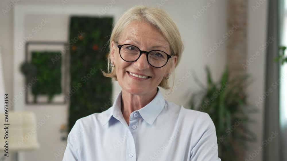 Portrait of one mature blonde caucasian woman with eyeglasses indoor Portrait of one mature blonde caucasian woman with eyeglasses indoor