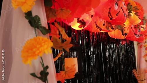 Scary party halloween decoration. Pumpkin buckets, skulls, tisue paper, maple leaves, lights, quinque, and cempasuchitl (marigold) flowers. Tilt. photo