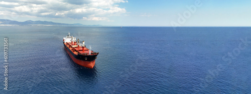 Obraz na płótnie Aerial drone ultra wide panoramic photo with copy space of huge industrial bulk carrier tanker anchored in deep blue Aegean sea w salonie