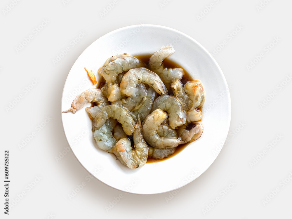 Plate with raw shrimp in teriyaki sauce on a white background, top view. Cooking Asian sea food. Plate with raw shrimp in teriyaki sauce on a white background, top view. Cooking Asian sea food.