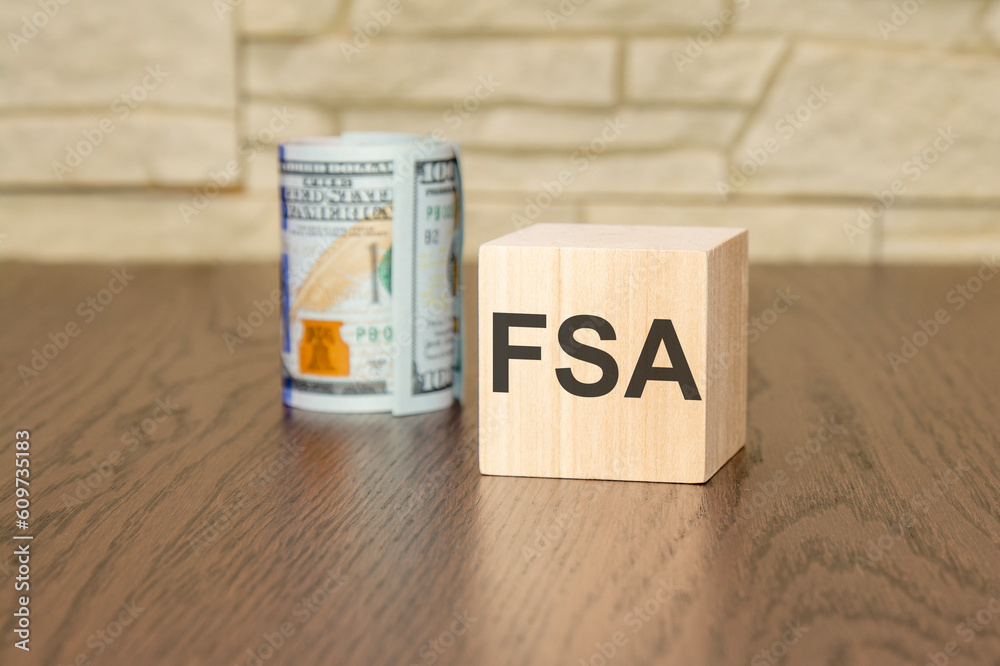 wooden block with text FSA on dark background - flexible spending account concept wooden block with text FSA on dark background - flexible spending account concept