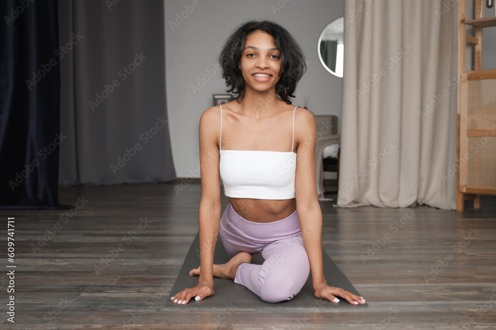Smiling Black Woman practicing yoga at home.Wellness concept banner with place for text. Smiling Black Woman practicing yoga at home.Wellness concept banner with place for text.