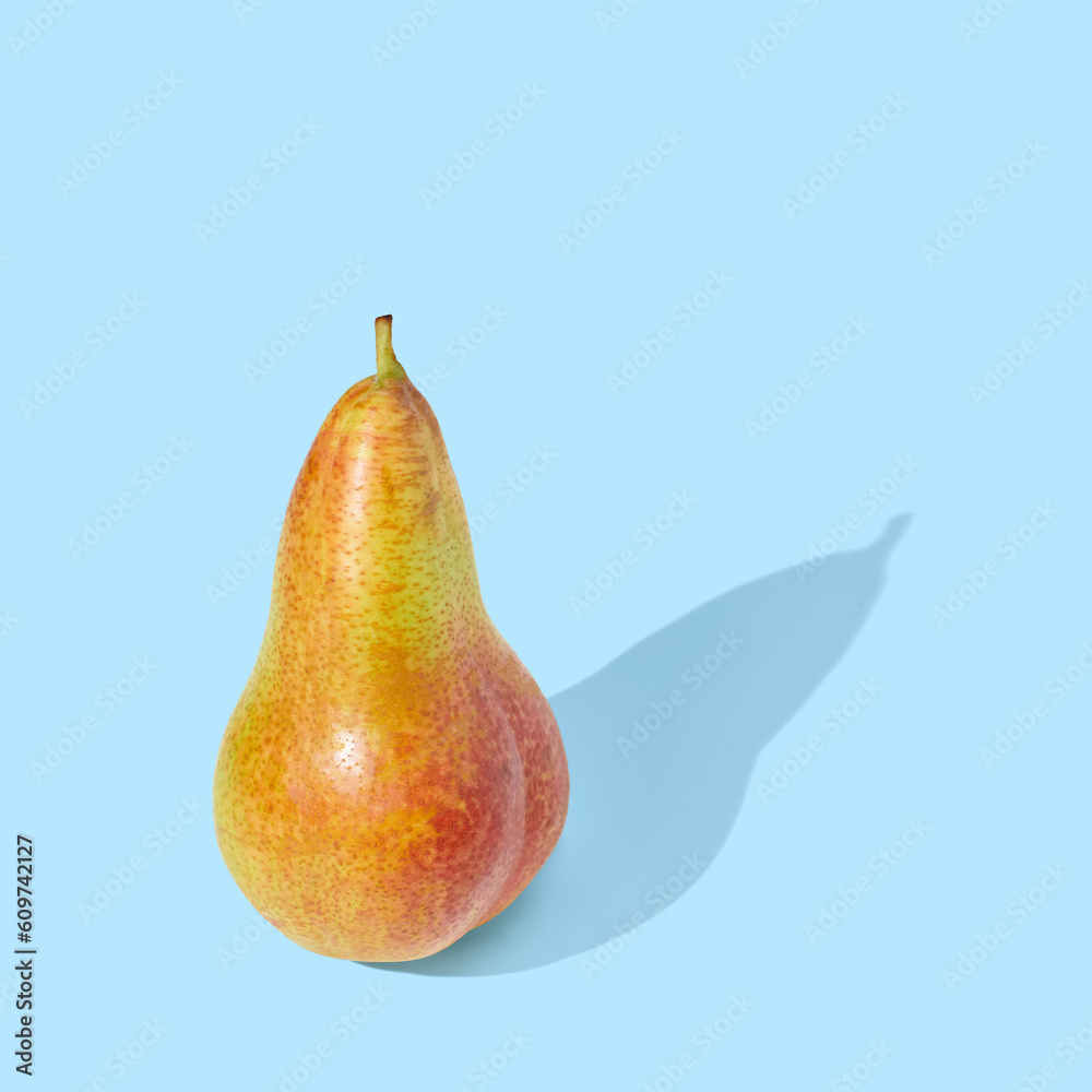 Pear with branch on blue pastel background Pear with branch on blue pastel background
