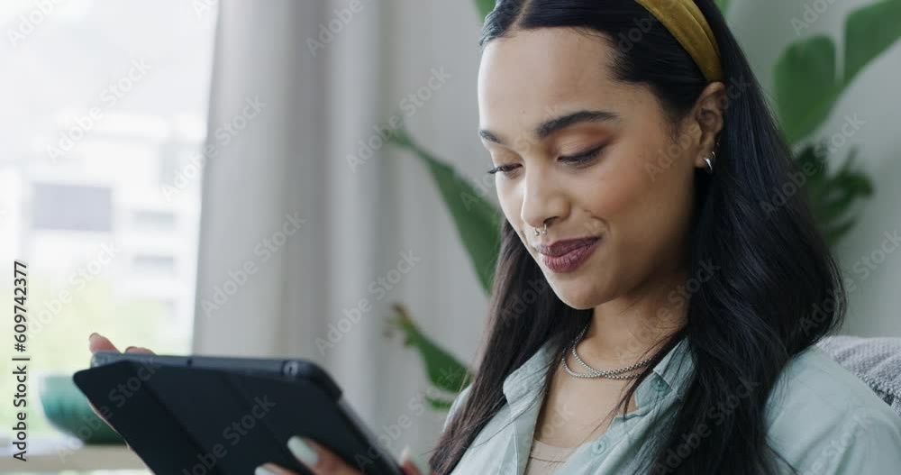 Happy woman, tablet and browsing online for social media or communication on living room sofa at home. Female person smiling and searching or scrolling on technology for networking on lounge couch