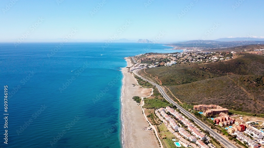 aerial view along the beach near Manilva with a view towards Torreguadiaro, Sotogrande and the Rock of Gibraltar and Africa at the horizon, Mediterranean Sea, Andalusia, Malaga, Spain