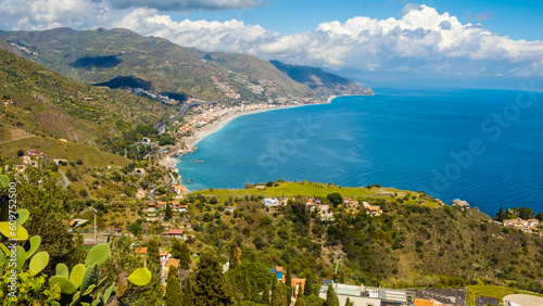 Landscape of Sicialian coast near Taormina town, Sicily, Italy. Mountains and azure waters of Ionian sea. Popular resort and tourist destination in southern Italy