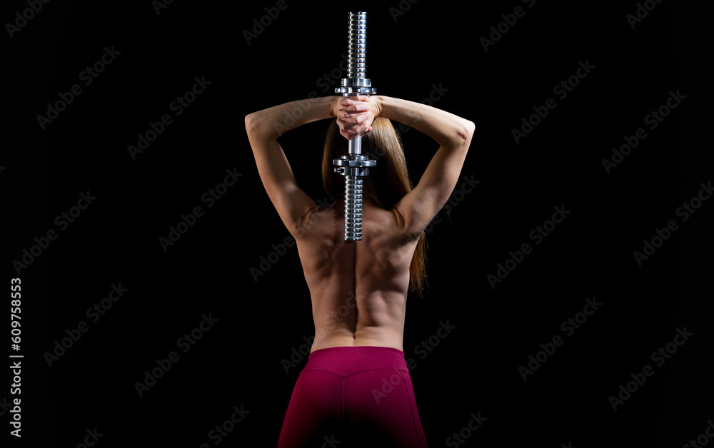 Athletic woman pumping up muscles with dumbbells, back. Woman sport body strong and back. Female nude muscular back. Strong woman workout with dumbbells. Sporty sexy muscular back.