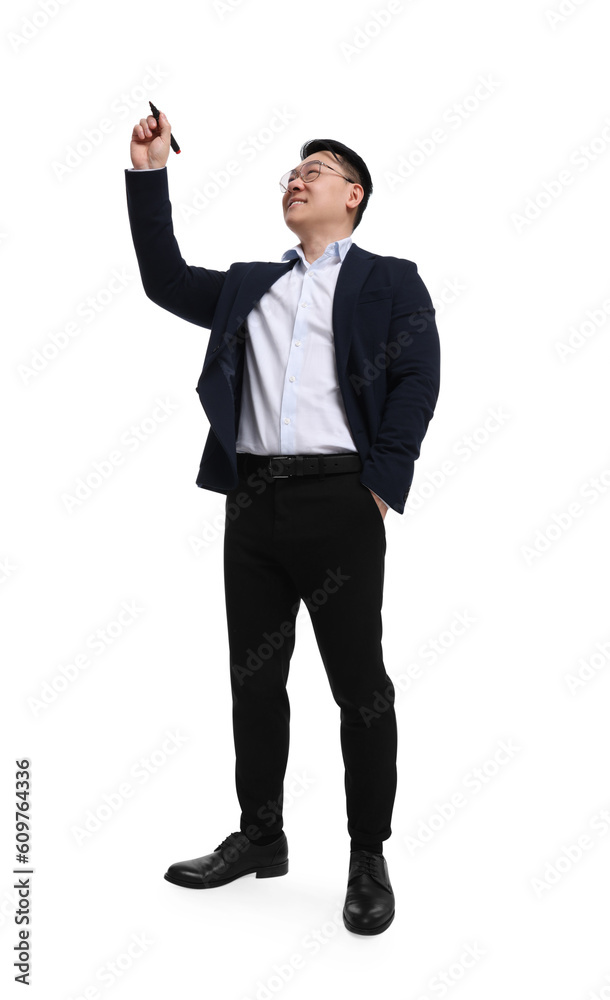 Businessman in suit with marker writing on white background, low angle view Businessman in suit with marker writing on white background, low angle view
