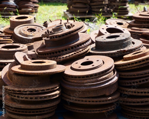 Fotografija A PIle of Rusty Discs Stacked in the Bright Sunlight in an Old Factory