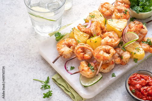 kebab skewers of barbecued shrimp with a pineapple