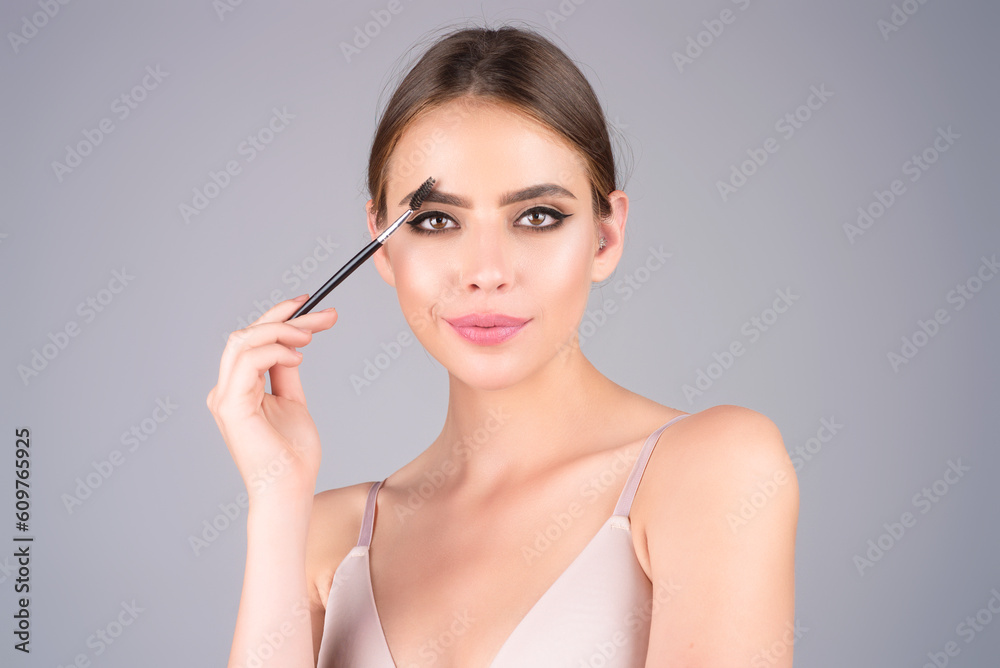 Woman comb eyebrows with eyebrow brush. Care for brows, eyebrows lamination. Brow beauty procedures. Beautiful woman with long eyelashes, eyebrows. Woman comb eyebrows with eyebrow brush. Care for brows, eyebrows lamination. Brow beauty procedures. Beautiful woman with long eyelashes, eyebrows.
